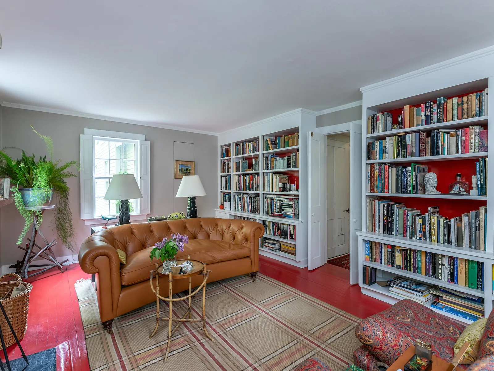 Library with fireplace and leather sofa